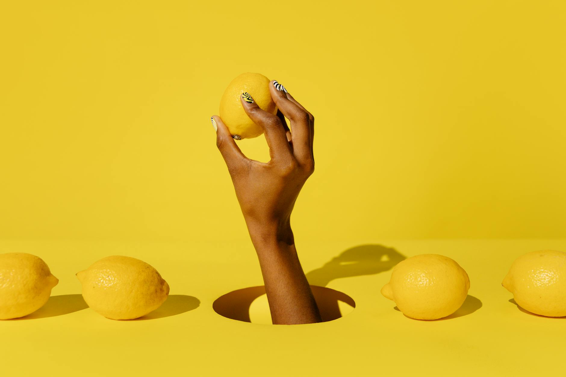 A woman holding a fresh lemon, symbolizing vitality and sensitivity during hormonal transitions