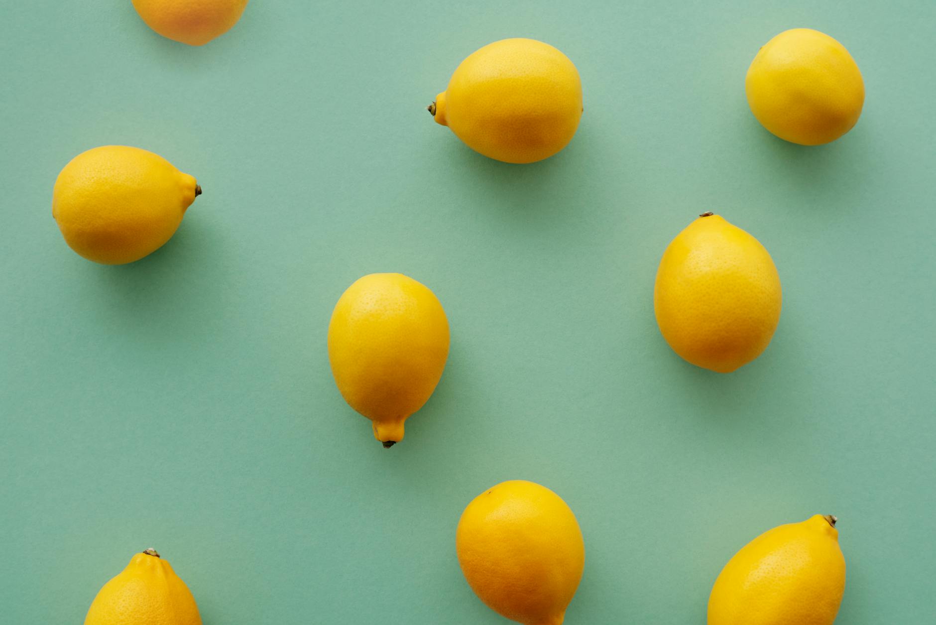 Bright yellow lemons arranged on a soft pastel background, symbolizing fresh starts and gradual healing.